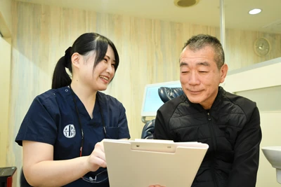 ボロボロの歯で痛みを感じない治療の説明風景/入れ歯の治療の説明風景/インプラントの治療の説明風景